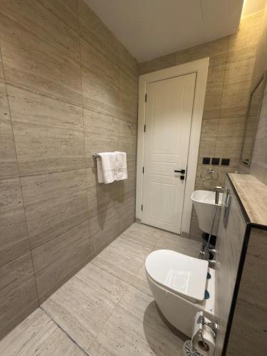 a bathroom with a white toilet and a sink at Riyadh Luxury Narjis in Riyadh