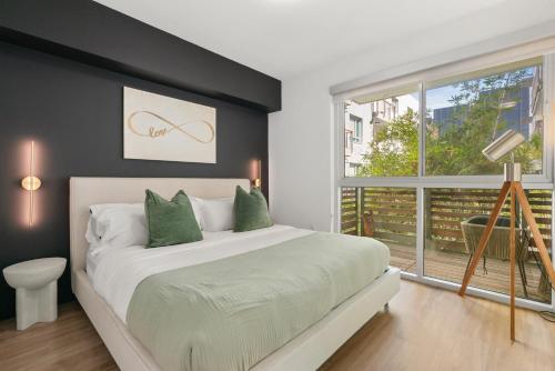 a bedroom with a large bed and a window at The Amber Serene Peaceful Retreat Pool Gym And Jacuzzi in Los Angeles