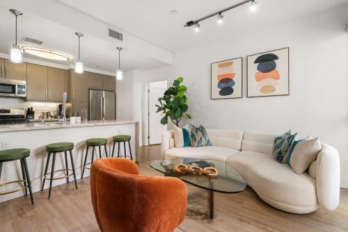 a living room with a couch and a table at The Amber Serene Peaceful Retreat Pool Gym And Jacuzzi in Los Angeles