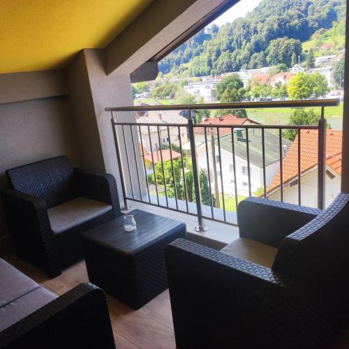 a room with chairs and a balcony with a view at Apartmaji Prʼ nas in Laško