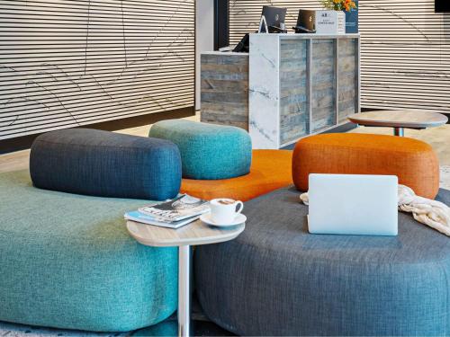 a room with two chairs and a table with a laptop at ibis Styles Paignton in Paignton