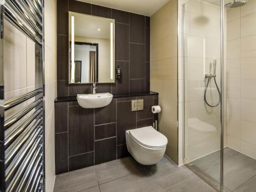 a bathroom with a toilet and a sink and a shower at ibis Styles Paignton in Paignton