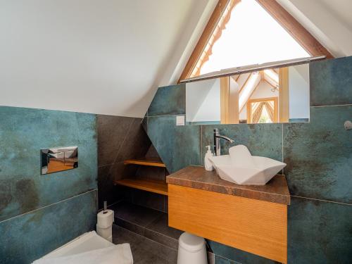 a bathroom with a sink and a skylight at Osada Gubałówka na Polanie Pająkówka View Jacuzzi & Sauna in Kościelisko