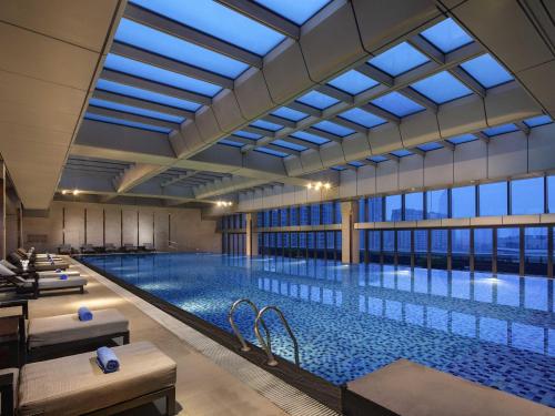 a large swimming pool with a large window at Pullman Haining in Haining