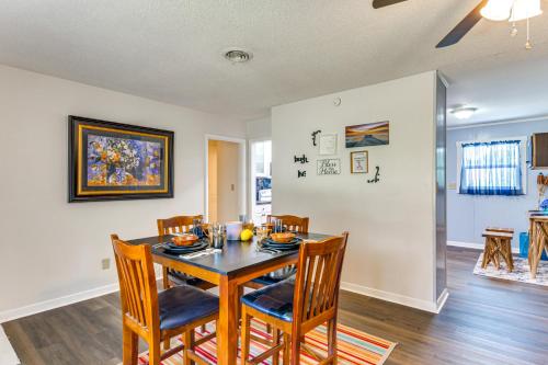 a dining room with a table and chairs at 6 Mi to Dtwn Pensacola Family-Friendly Gem! in Pensacola