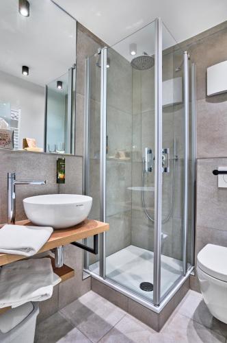 a bathroom with a shower and a sink at Gasthaus Hotel Ostermeier in Attenkirchen