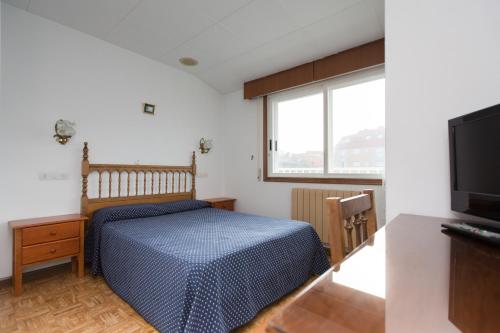 a bedroom with a bed and a flat screen tv at My Rooms City Hotel Monte Blanco in Neaño