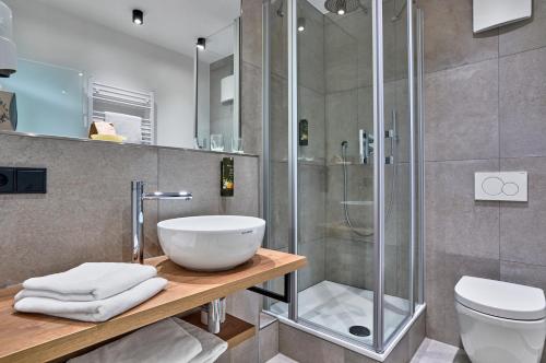 a bathroom with a sink and a shower at Gasthaus Hotel Ostermeier in Attenkirchen
