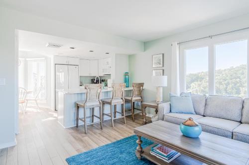 a living room with a couch and a table at Port O' Call G304 - Modern Oceanview! Atlantic Escape! in Isle of Palms