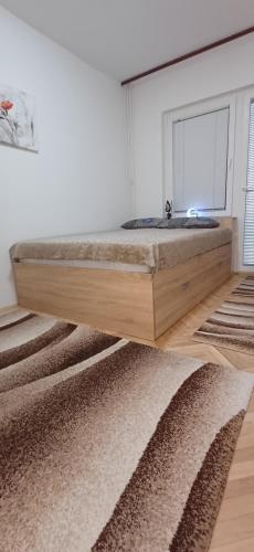 a bedroom with a bed with a sink and a rug at Stan so prekrasen pogled in Bitola