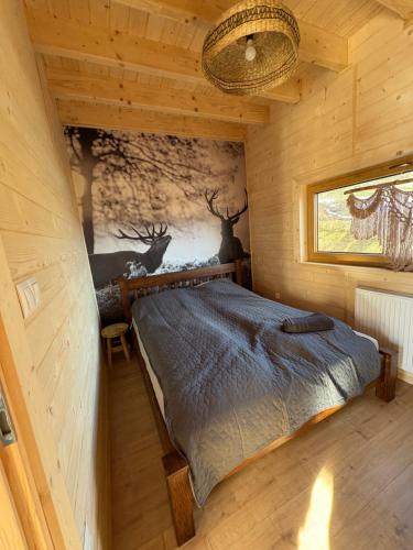 a bedroom with a bed in a log cabin at Jodełkowa Stodoła in Tylmanowa