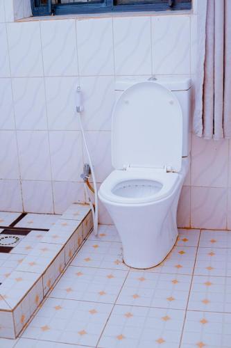 a dirty bathroom with a toilet and a tub at Holliday inn kigali in Kigali