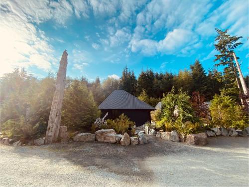 a gazebo in a garden with trees at Fern's Edge in Port Renfrew