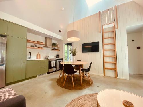 a kitchen and dining room with a table and chairs at Fern's Edge in Port Renfrew