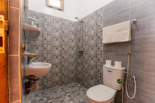 a bathroom with a toilet and a sink at The best apartments of Ourika valley in Amlouggui