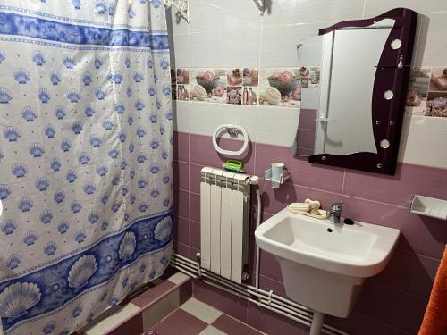 a bathroom with a sink and a shower curtain at Étage de villa Elkala in El Kala