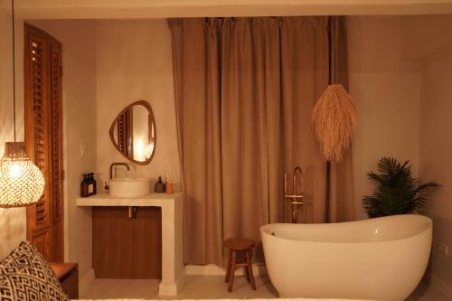 a bathroom with a bath tub and a sink at Couples Suites at Ocean Park Beach Club in San Juan