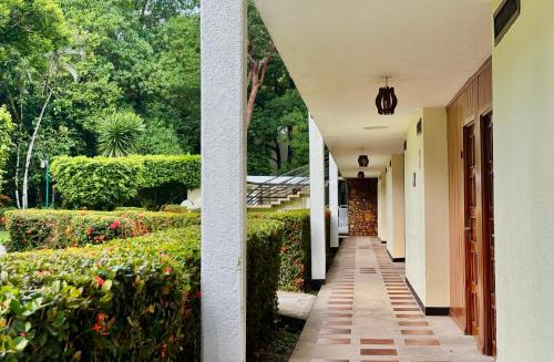 a hallway of a house with a garden at Hotel Nututun Palenque in Palenque