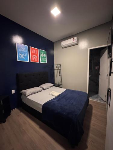 a bedroom with a bed and signs on the wall at On Park Hotel e Traslado in Guarulhos