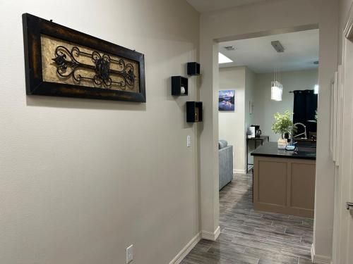 a hallway of a home with a painting on the wall at Quiet 2BR Retreat , Fenced yard , Modern Duplex in Harlingen