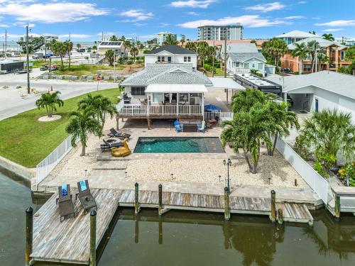 an aerial view of a house with a swimming pool at Boating Enthusiasts, Walk to the Beach, Heated Pool - The Corner cottage - Roelens in Fort Myers Beach