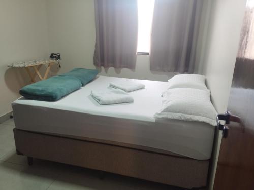 a bed with two pillows on it in a room at casa nova no guara proxima ao aeroporto in Brasilia