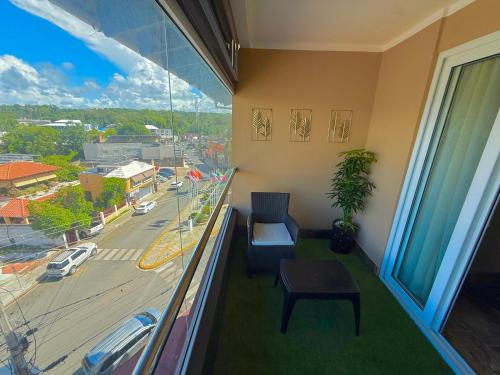 a room with a balcony with a view of a street at Sosua Inn Hotel in Sosúa