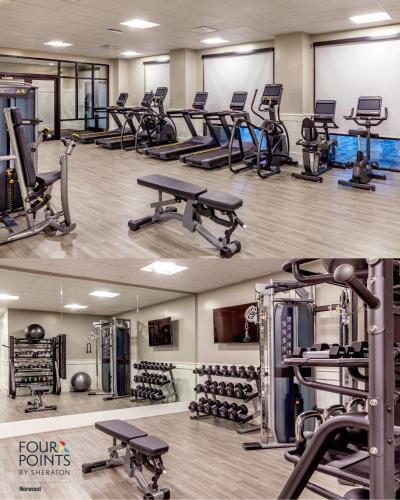 a gym with a lot of treadmills and machines at Four Points by Sheraton Norwood Conference Center in Norwood