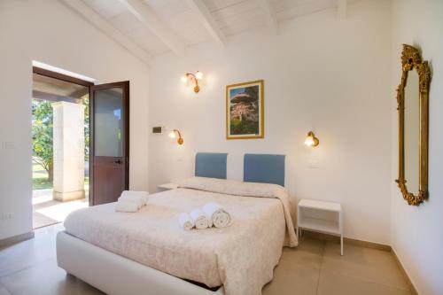 a bedroom with a bed with two towels on it at Agriturismo il Contadino in Otranto