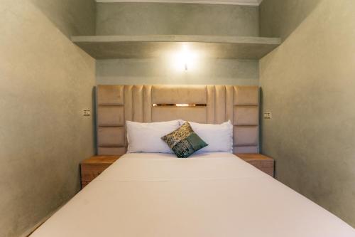 a large white bed in a small room at The best apartments of Ourika valley in Amlouggui