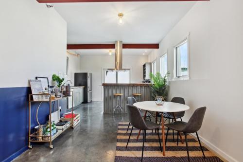 a kitchen and dining room with a table and chairs at Warehouse District Lovely One Bedroom and Den in New Orleans