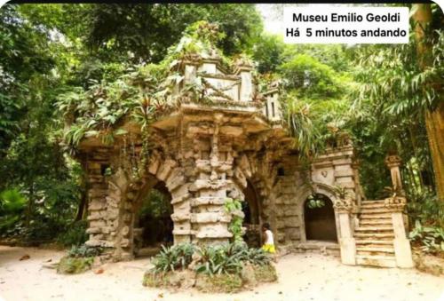 a person standing in front of a stone building at Quarto Casal em Belém in Belém