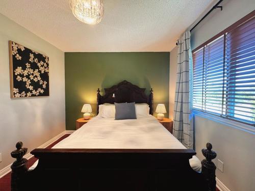 a bedroom with a large bed and two lamps at Spacious 4B2B HOUSE DTLA & Disney Office Gym in Hacienda Heights