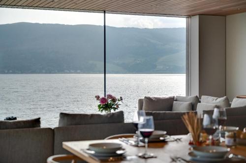 a dining room with a view of the water at Rock Cove in Cove