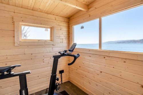 a room in a wooden cabin with a bike in it at Rock Cove in Cove