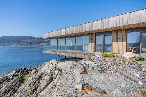 a house on the shore of a body of water at Rock Cove in Cove