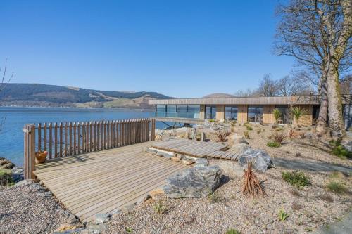 a wooden deck next to a body of water at Rock Cove in Cove