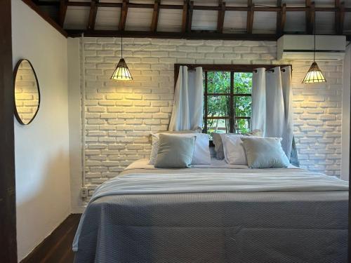 En eller flere senge i et værelse på Pousada Jardim das Bromélias