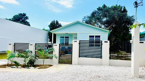 a white garage with a black and white gate at Ostiones Beach Property in Garita