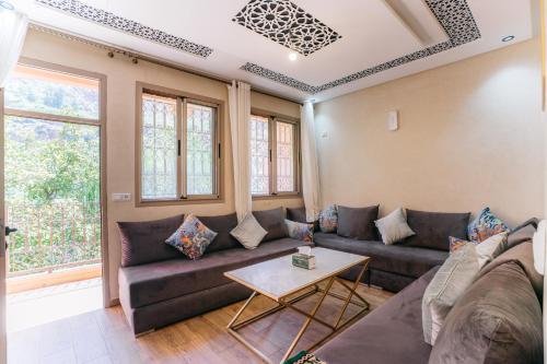 a living room with a couch and a table at The best apartments of Ourika valley in Amlouggui