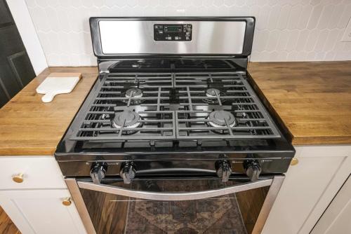 a stove top oven sitting on top of a kitchen counter at Downtown Lafayette Gem-1BR House with Free Parking in Lafayette