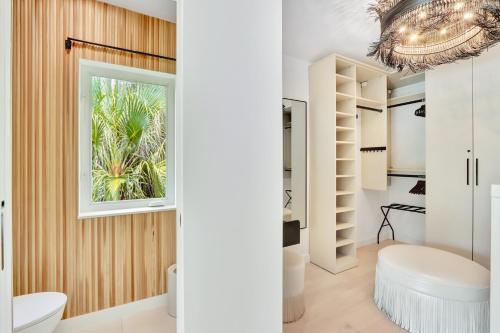 a bathroom with white fixtures and a window at Sirena Key - Luxury Oceanfront Estate, Pool, Guest Cottage, Dock, 30min to Key West in Summerland Key