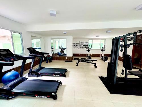a gym with several treadmills and machines in a room at Elegance Residences Cumbuco in Caucaia
