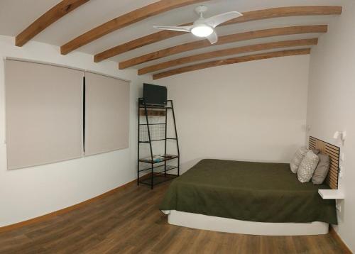 a bedroom with a bed and a ceiling fan at Amendoeira House - House in Ponta do Sol in Ponta do Sol