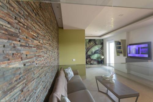 a living room with a brick wall and a couch at B&B Dream House in Campobasso