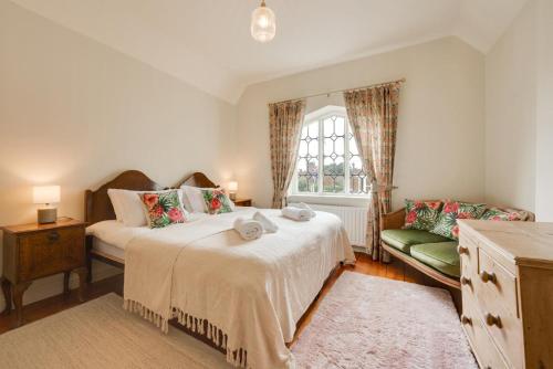 a bedroom with a large bed and a window at The Dutch House in Snettisham