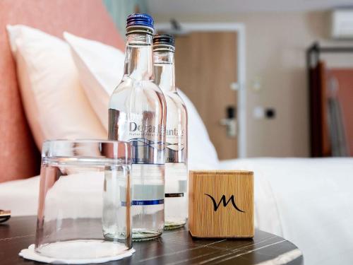 two bottles of water and a glass on a table at Mercure Thurrock Stifford Hall in Grays Thurrock