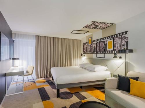 a hotel room with a bed and a couch at ibis Styles Tallinn in Tallinn