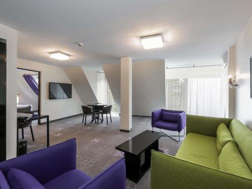 a living room with a couch and chairs and a table at ibis Styles Tallinn in Tallinn