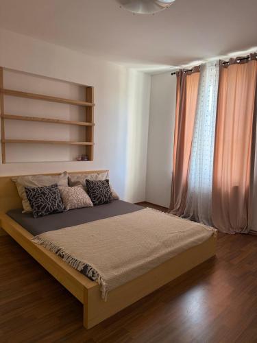 a bedroom with a large bed in front of a window at CosyCentrumFlat in Slezská Ostrava